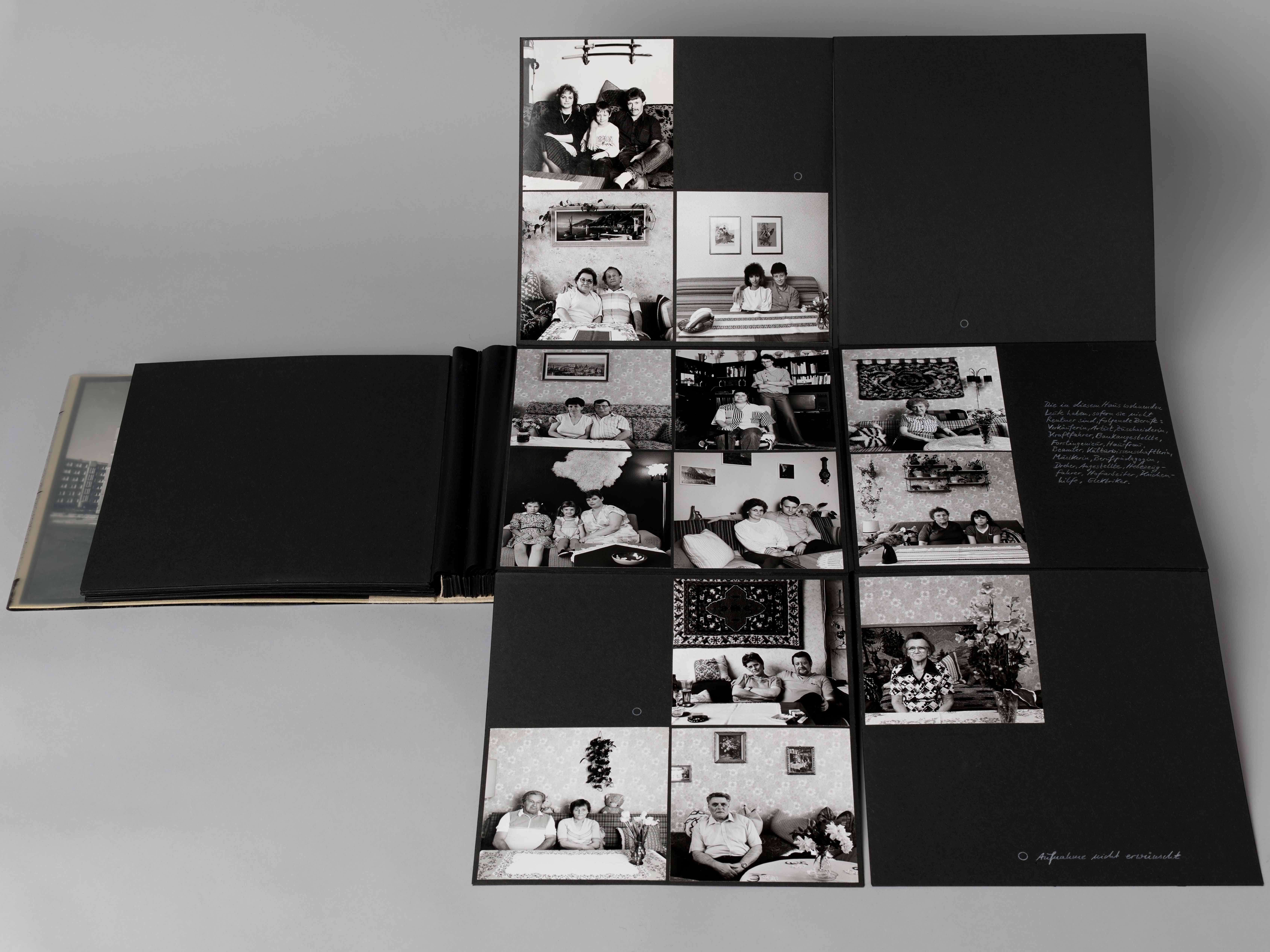 KI generiert: Das Bild zeigt ein Fotoalbum mit mehreren Schwarzweißfotos, die verschiedene Momente oder Personen in einem häuslichen Umfeld festhalten. Das Album ist geöffnet und die Fotos sind auf mehreren Seiten verteilt.